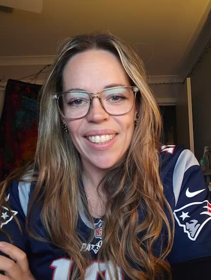 Alysha at home, wearing a football jersey